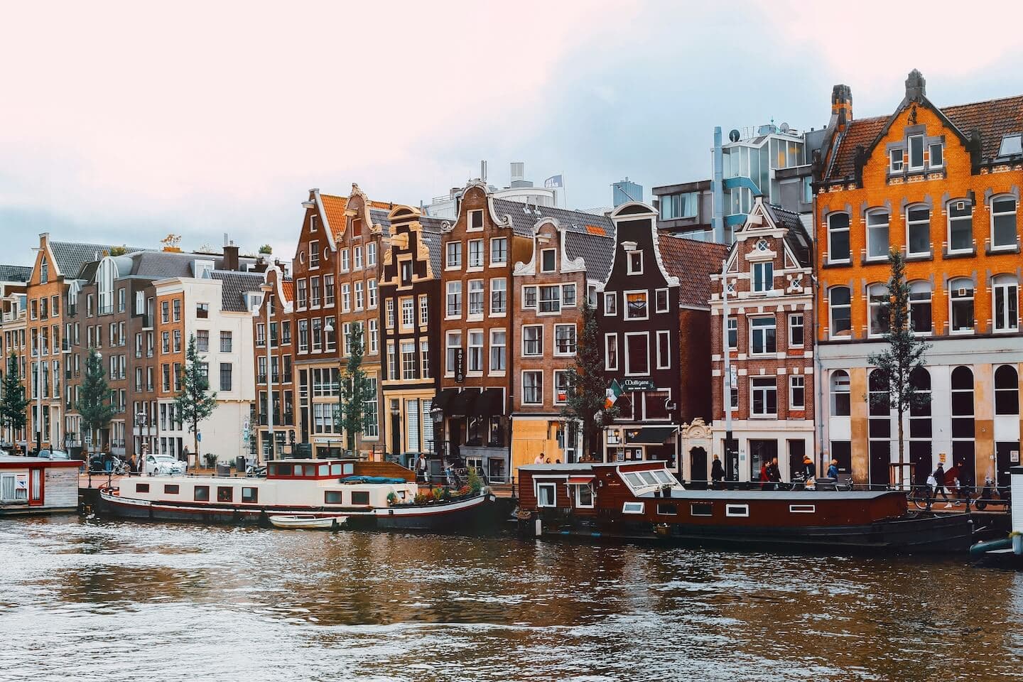 Amsterdam canal with traditional Dutch houses and bicycles along the waterfront